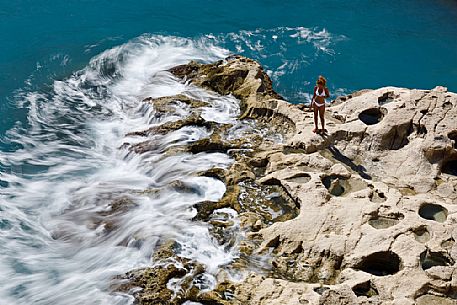 Summer holiday on the rocky coast of St. Peter's Pool, one of the most beautiful natural pools on the island of Malta, Europe