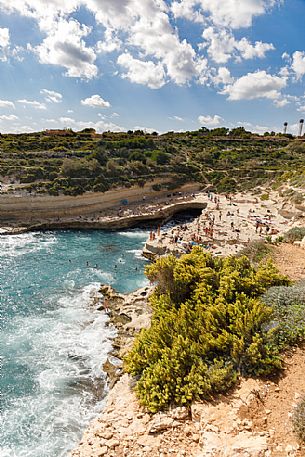Summer holiday in St. Peter's Pool, one of the most beautiful natural pools on the island of Malta, Europe
