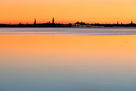 Sunset towards the island of Venice from the colorful island of Burano, Veneto, Italy, Europe