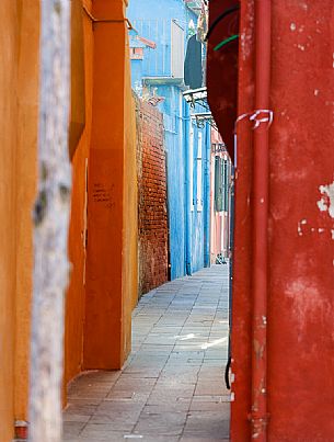 The colored houses in a typical alley of Burano village, Venice, Italyl, Europe