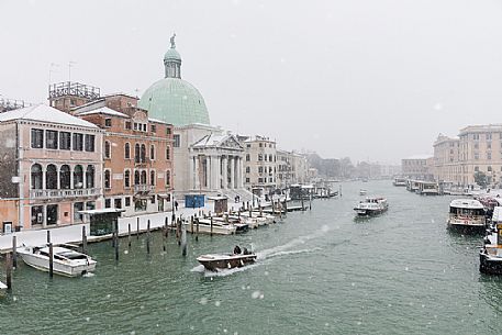 Venice in a snowy day, San Simeone church and the medieval houses from Scalzi bridge on the Grand Canal, Italy, Europe