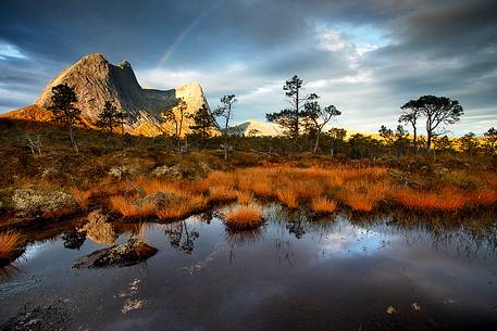 Raibow, rocky mountains and autumn colors in Nordland region, northern Norway.