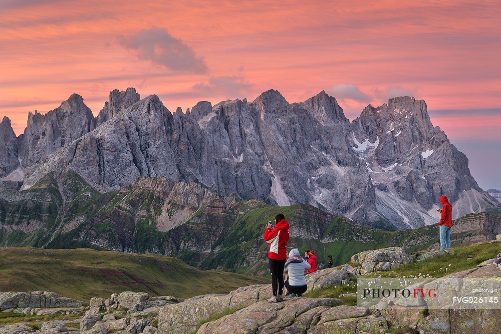 Hikers admire the Pale di San Martino mountains, Col Margherita, Trentino, Italy
