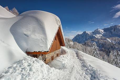 Cottage under snow in Sanctuary Mont Lussari