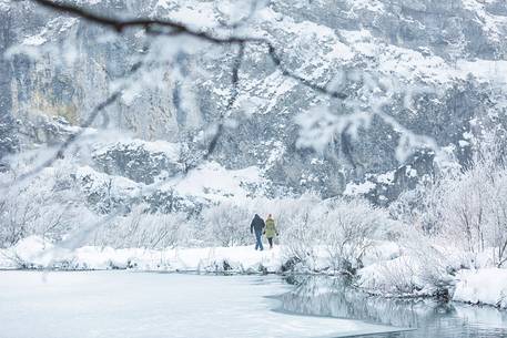 Tourists walking in the winter landscape of Plitvice Lakes National Park, Croatia