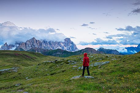 Hiker admires the Pale di San Martino mountains, Col Margherita, Trentino, Italy