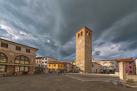 Town square with clock tower of Marano Lagunare village, Friuli Venezia Giulia, Italy
