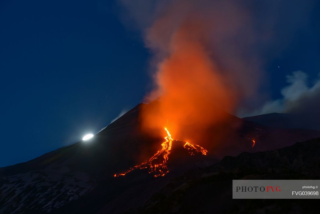 Etna and the moon in a nighttime eruption, Etna mount, Sicily, Italy, Europe