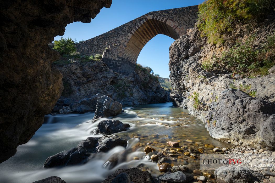 Front view of the ponte dei saraceni bridge, an ancient medieval bridge of Norman age located on the Simeto river, near Adrano, Catania, Sicily, Italy

