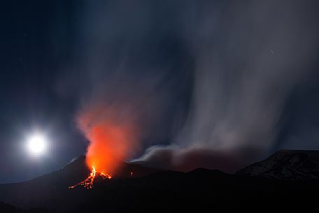 Etna and the moon in a nighttime eruption, Etna mount, Sicily, Italy, Europe