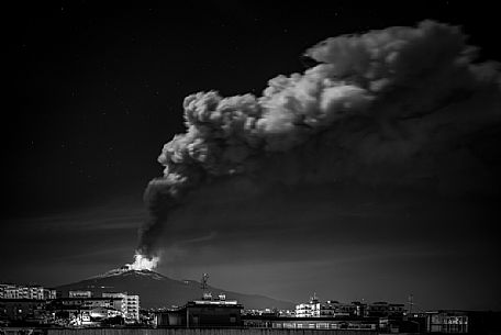 Nightscape of Catania town and the eruption of the Etna volcano, Sicily