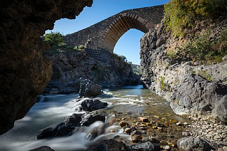 Front view of the ponte dei saraceni bridge, an ancient medieval bridge of Norman age located on the Simeto river, near Adrano, Catania, Sicily, Italy
