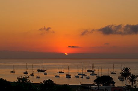 Sunset with boat in Stromboli island, Sicily, Italy