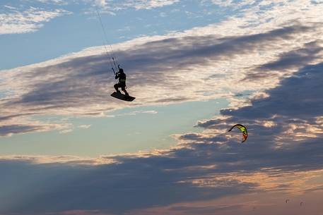 Kitesurfer and kites in the sky of Grado