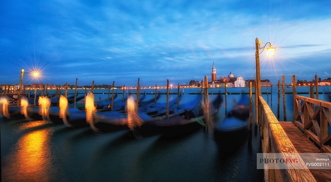Evening's lights on the gondolas in St. Mark's basin in Venice, in the background the Church of San Giorgio Maggiore, Venice, Italy, Europe