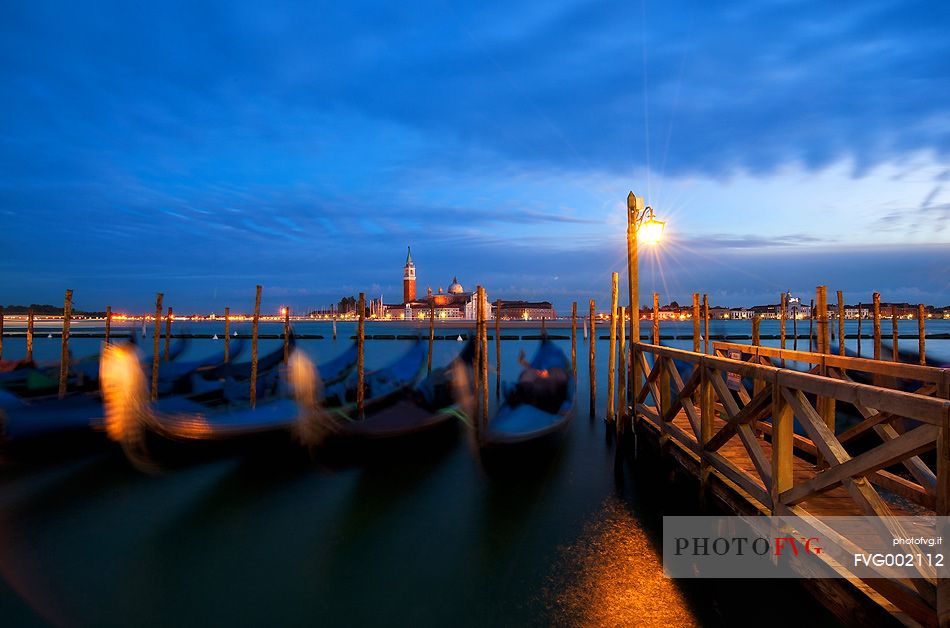 Evening's lights on the gondolas in St. Mark's basin in Venice, in the background the Church of San Giorgio Maggiore, Venice, Italy, Europe