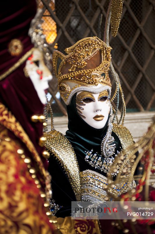Carnival masks in glittering clothes, Venice