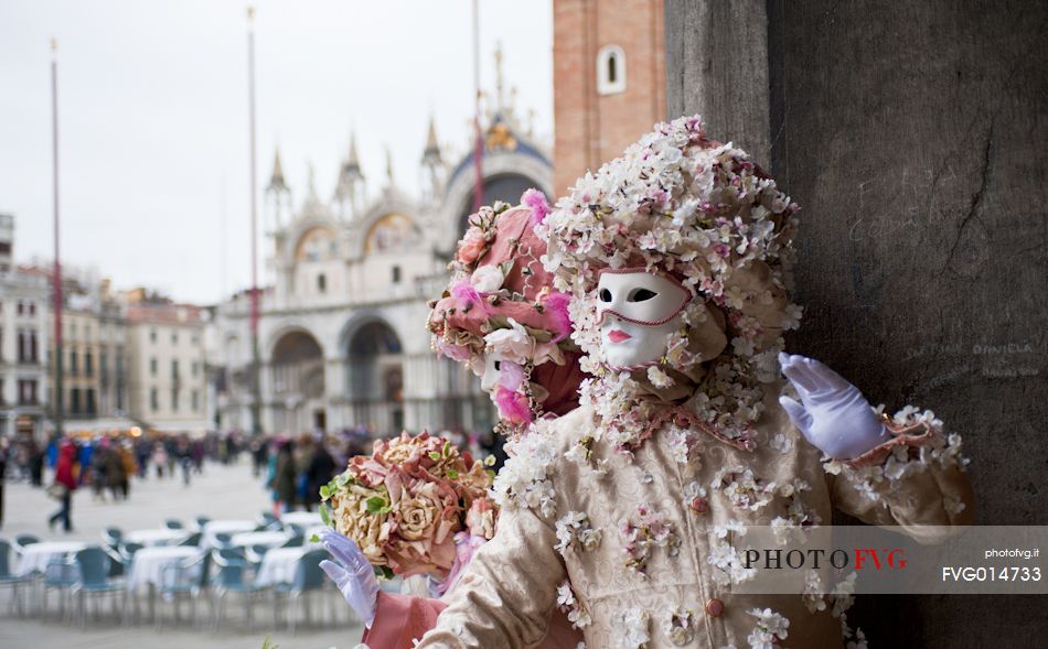 Masks in St. Mark's Square in Venice, in the background the Basilica of San Marco, Venice, Italy
