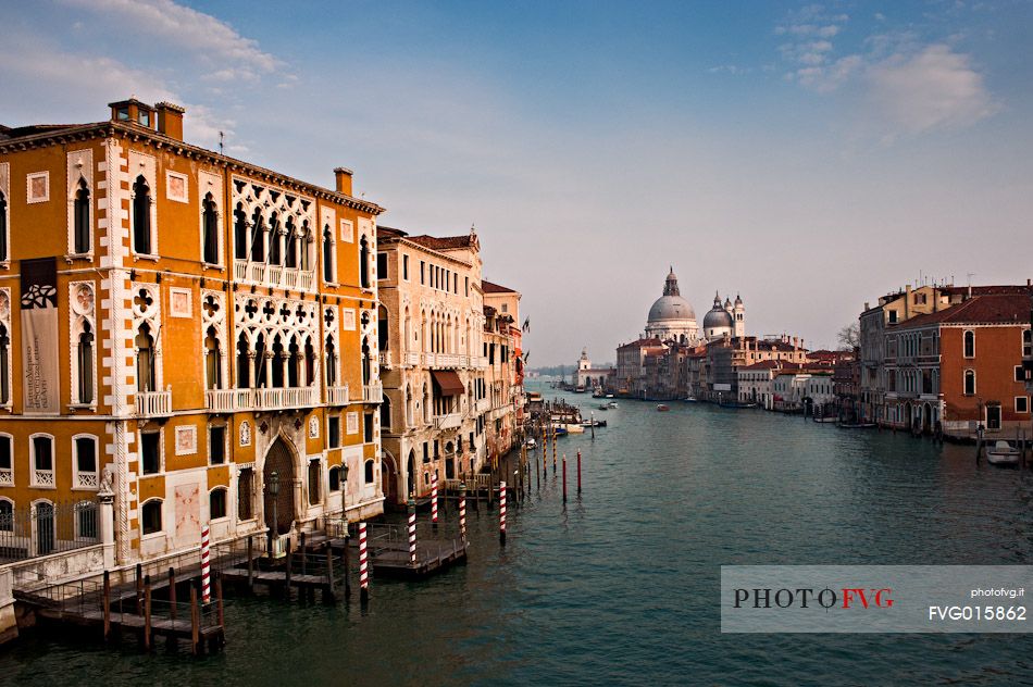 The Canal Grande, in the background the church Santa Maria della Salute,  located at Punta della Dogana in the Dorsoduro sestiere of the city of Venice, Italy