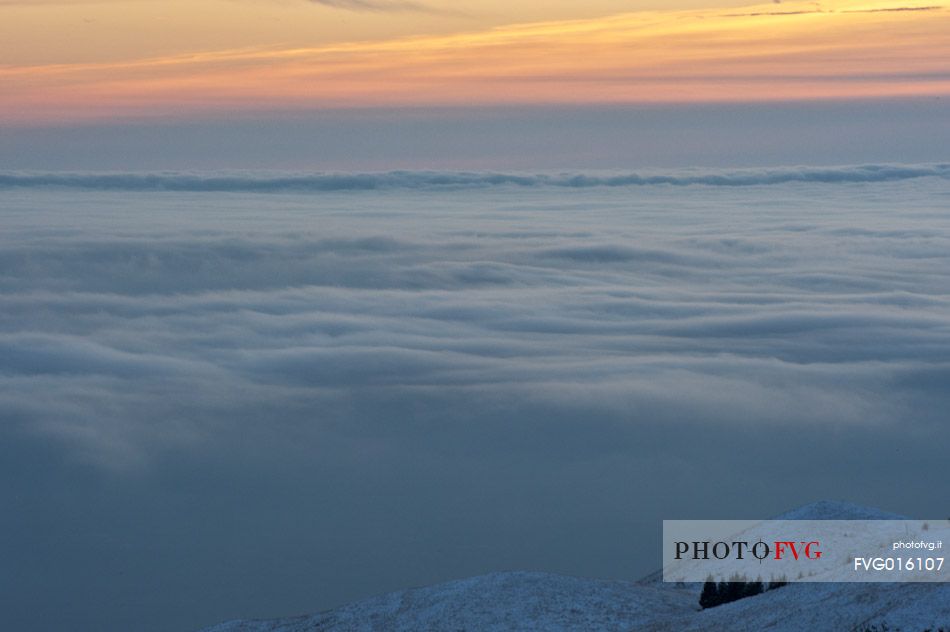 Clouds covered the Friuli lands, view from the ridge of Mount Cavallo. Friuli Venezia Giulia, Italy, Europe