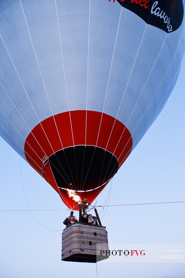 People have fun flying in a hot air balloon during the hot air balloon festival in Udine, Friuli Venezia Giulia, Italy, Europe