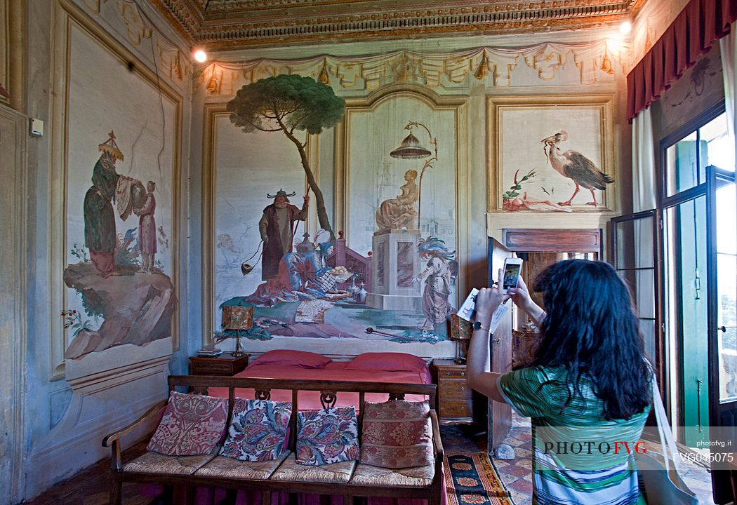 A tourist photographs the frescoes in the 