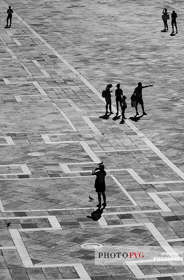 Tourists in Piazza San Marco in Venice on a warm sunny day. Italy