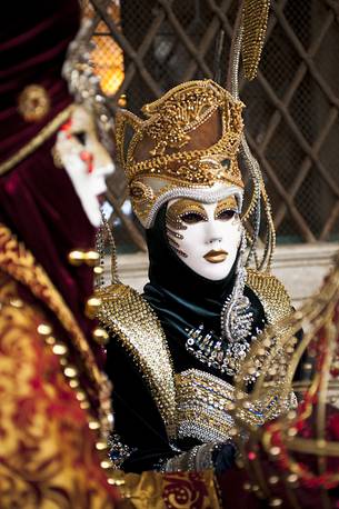 Carnival masks in glittering clothes, Venice