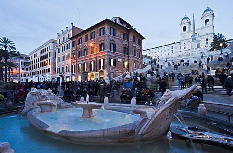 Piazza di Spagna, at the bottom of the Spanish Steps, is one of the most famous squares in Rome. In the foreground the famous Fountain Barcaccia (Bernini). Rome, Italy, Europe