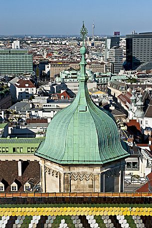 The north bell tower of the saint Stephen cathedral in Vienna, in the background a view of the city. Vienna. Austria