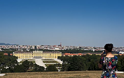 A girl photographs the Schönbrunn Palace in Vienna. It is an imperial summer residence and  a baroque palace, one of the most important architectural, cultural, and historical monuments in Austria.