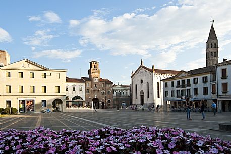 Great Square or Piazza Grande in Oderzo town. In the background the Trevisana Door or torresin, symbol of the city, and the St. John's Baptist's cathedral. Veneto, Italy.