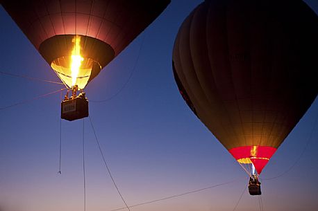 Illuminated hot air balloons in the sky at sunset. Balloon Festival of Udine, Friuli Venezia Giulia, Italy, Europe