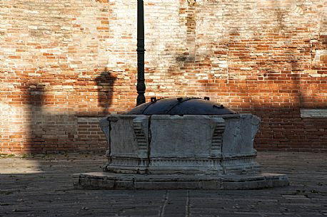 Ancient Venetian stone well in the S. Agnese field in the Dorsoduro district of Venice, Italy, Europe