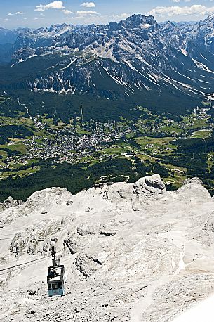 The Freccia del Cielo cable car to Cima Tofana peak, in the background the Cortina d'Ampezzo town, Cadore, dolomites, Italy