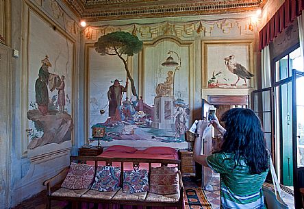 A tourist photographs the frescoes in the 