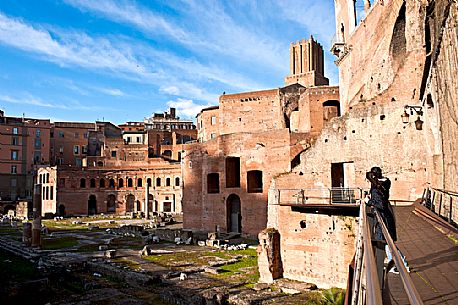 Tourists admire the archaeological site of the Imperial Forums, the center of political activity in ancient Rome, Italy, Europe