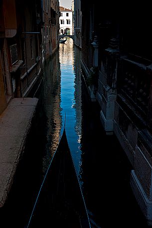 A gondola sails through the narrow canals of Venice, Italy, Europe