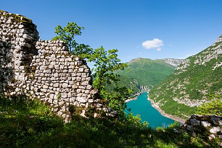 The artificial lake of Ravedis in the territory of Montereale Valcellina in the province of Pordenone and the remains of the ancient castle.  In the background, Mount Pala D'Altei. Italy