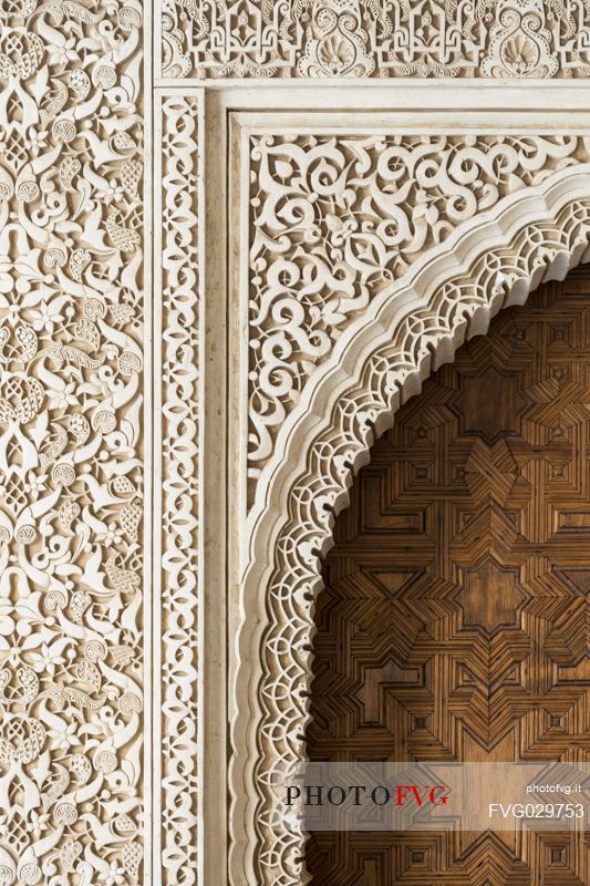 Detail of a door and wall decoration in the Arrayanes Patio, part of teh Nazaries Palace, in the Alhambra complex, Granada, Spain
