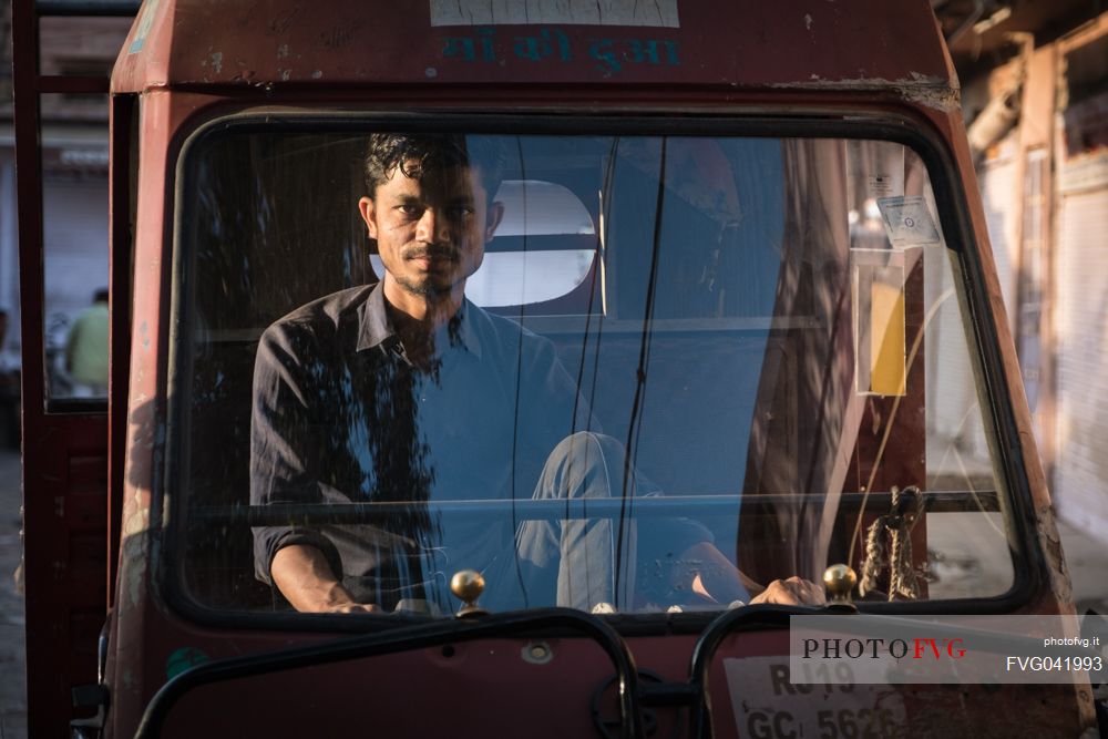 Portrait of young Indian man driving his van, Jodhpur, Rajasthan, India