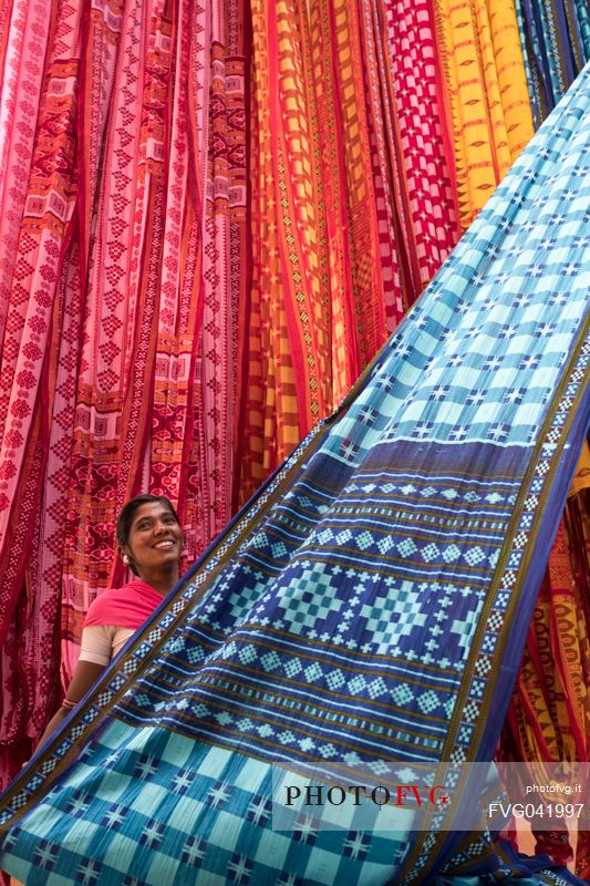 Woman working in a sari factory shows the colorful textiles, Rajasthan, India