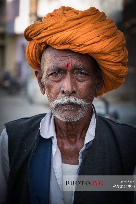 Portrait of old rajasthani Indian man with orange turban, Pali, Rajasthan, India