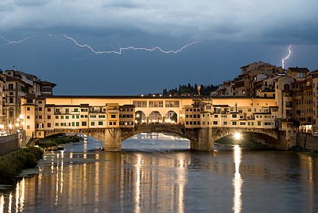 Ponte Vecchio during an evening storm in the background. Lightenings crossing the sky, Florence, Tuscany, Italy