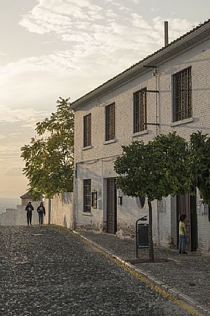 A street of the Albaicin or Albayzn arab quarter in Granada during sunset, Spain
