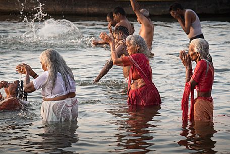 Indian Hindu pilgrims bathing in the Ganges river in Holy City of Varanasi, Benares, India