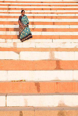 Local woman descending the steps of a ghat in Varanasi, Uttar Pradesh, India