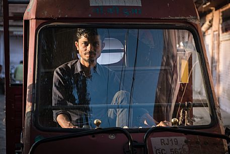 Portrait of young Indian man driving his van, Jodhpur, Rajasthan, India