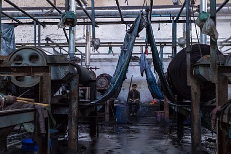 Worker in a textile factory in the commercial district of Pali, Rajasthan, India