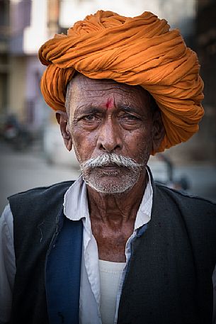 Portrait of old rajasthani Indian man with orange turban, Pali, Rajasthan, India